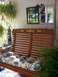 Cozy porch swing for relaxing with your morning coffee