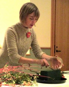 Emily demonstrates cutting the floral oasis.