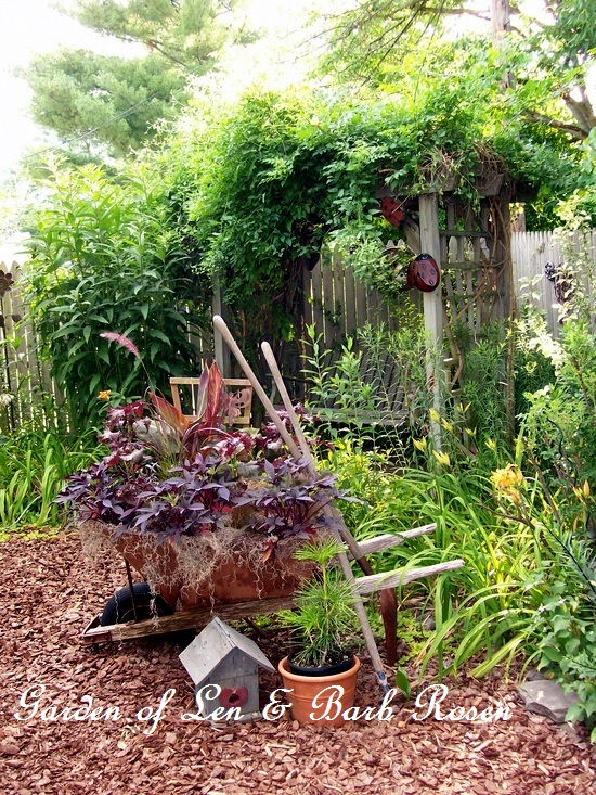 Wheelbarrow planting https://ourfairfieldhomeandgarden.com/a-trip-down-memory-lane-my-former-garden/