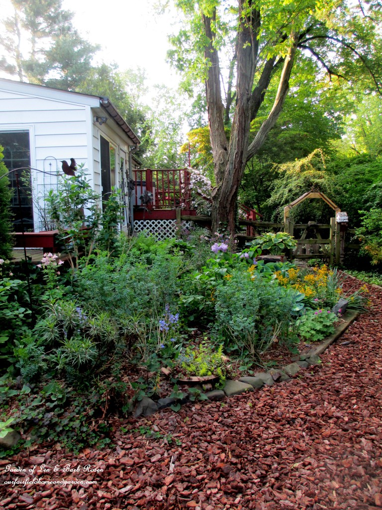 Garden Room replaced the single garage and a shade flower bed and arbor are now part of the scene.