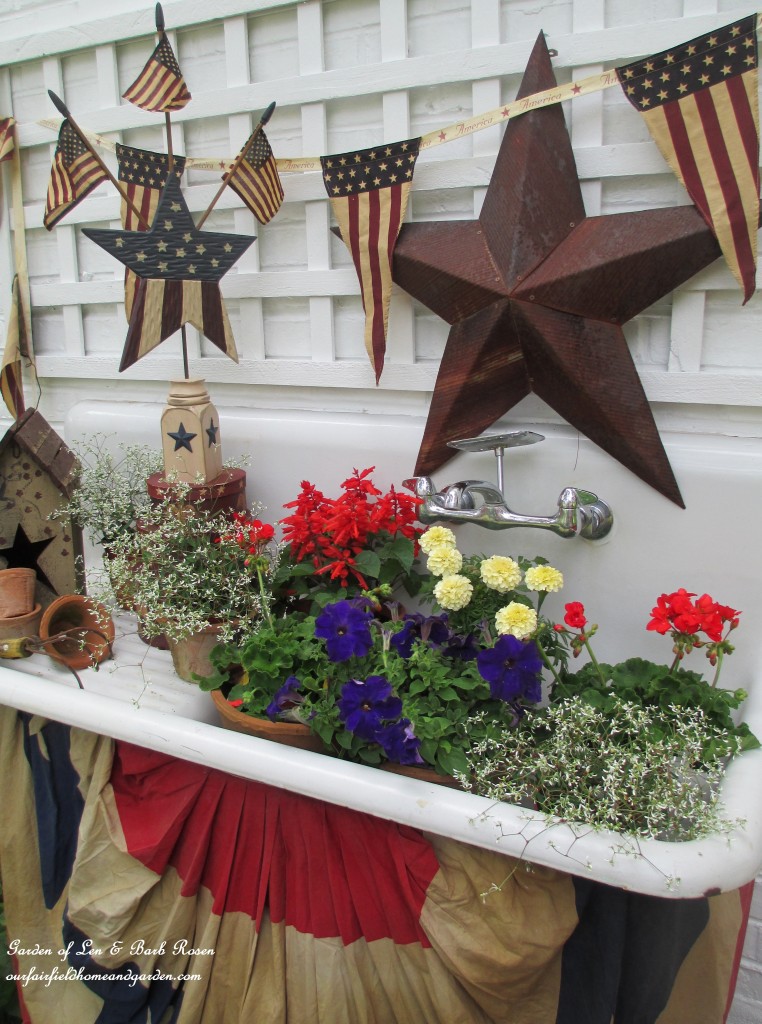 Tea stained banner and drape for a vintage sink. https://ourfairfieldhomeandgarden.com/happy-4th-of-july-patriotic-potting-sink/