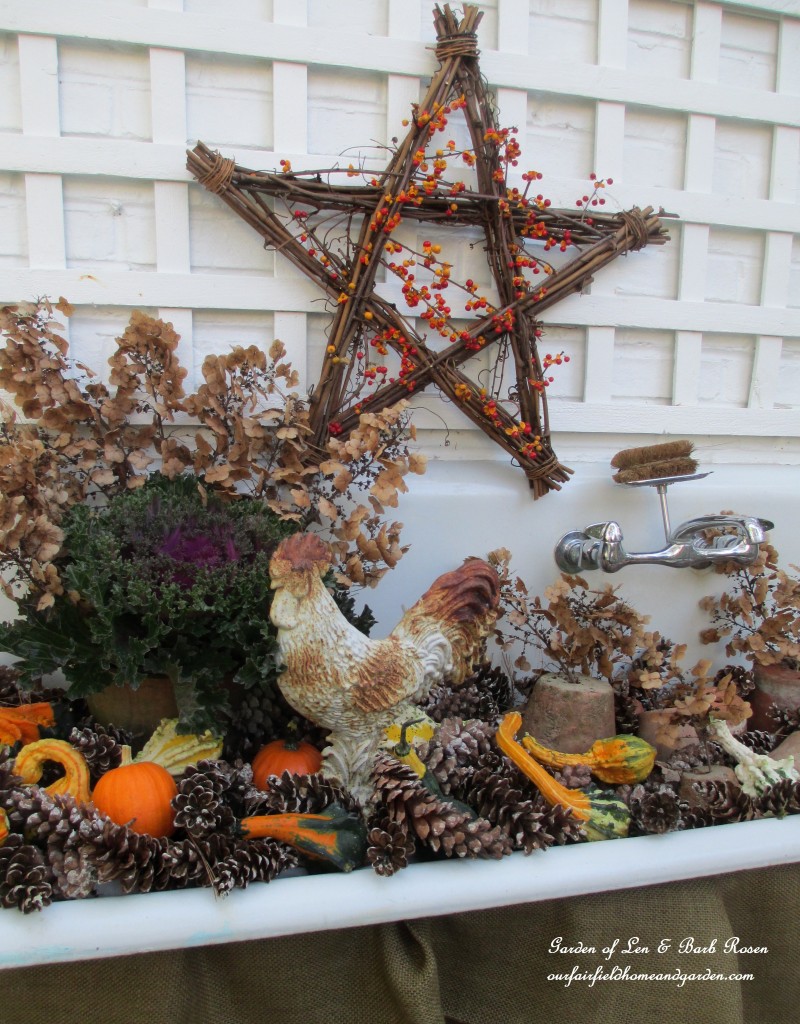 Fall Potting Sink filled with gourds, pinecones, kale and flowerpots. https://ourfairfieldhomeandgarden.com/autumn-garden-accents-inside-and-out/