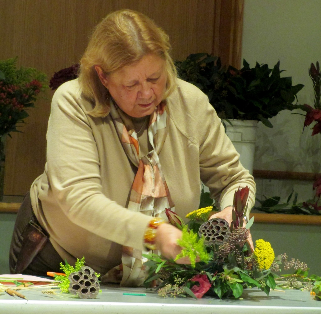 Brenda Tunis demonstrating the steps in constructing a floral cornucopia.