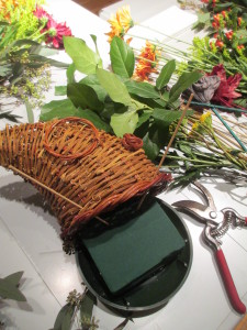 https://ourfairfieldhomeandgarden.com/diy-thanksgiving-cornucopia/ Gather the materials and remember to start at the base with greens to cover the oasis, then add accent pieces & flowers.