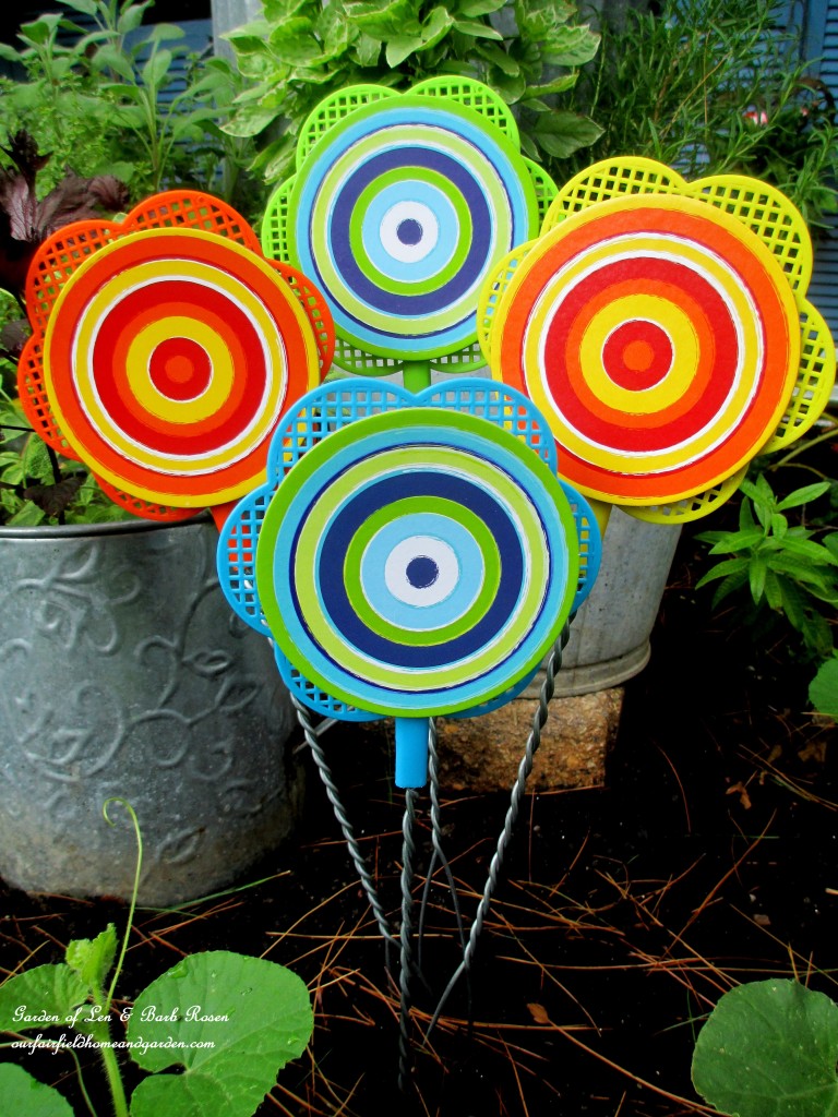 Dollar Store Flyswatter Flowers https://ourfairfieldhomeandgarden.com/kitschy-kitchen-garden-accents/
