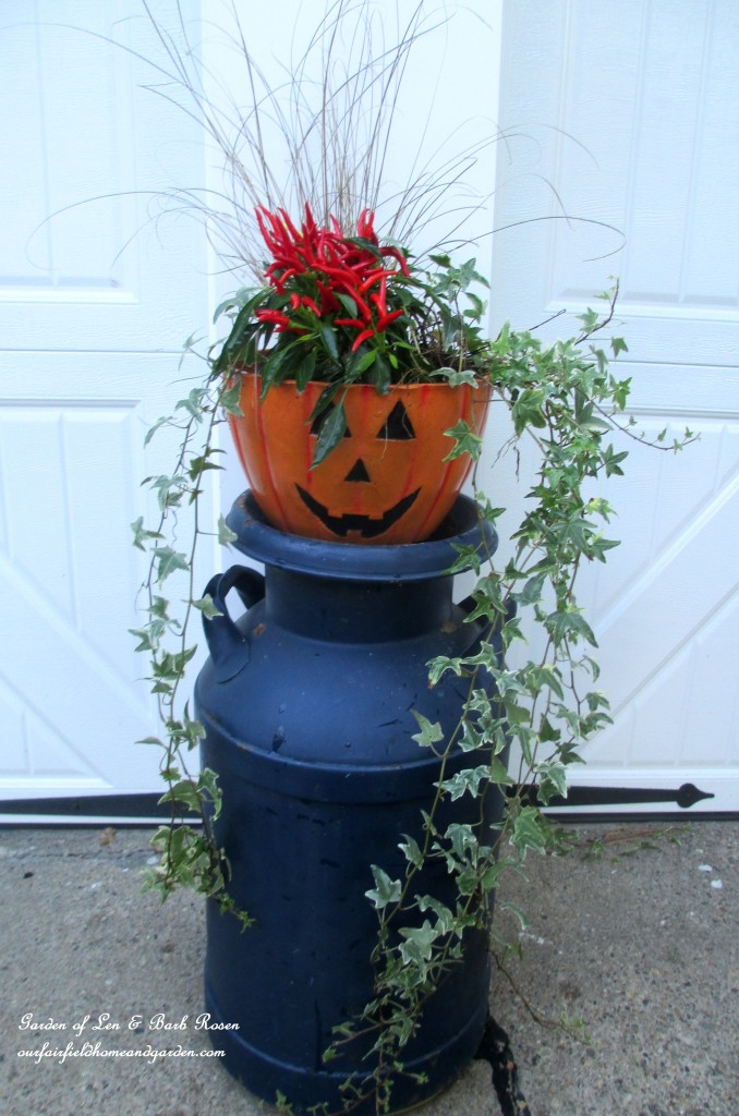 Fall planter on a milk can stand https://ourfairfieldhomeandgarden.com/fall-outdoor-decor-our-fairfield-home-and-garden/
