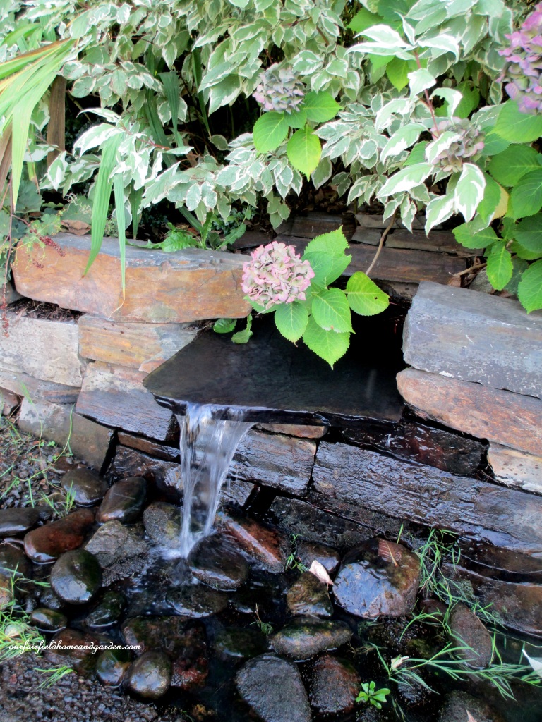 Stone Wall Fountain https://ourfairfieldhomeandgarden.com/unexpected-garden-accents/