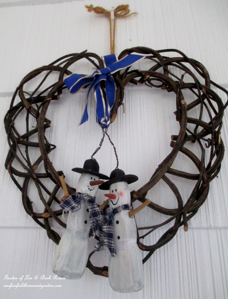 Snowman Wreath https://ourfairfieldhomeandgarden.com/rustic-watering-cans-windowboxes-more/