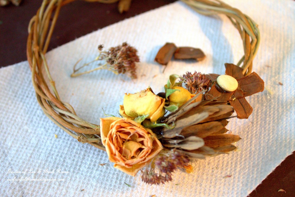 Hot glue was used to attach dried materials to a small wreath. https://ourfairfieldhomeandgarden.com/diy-spring-wreaths/