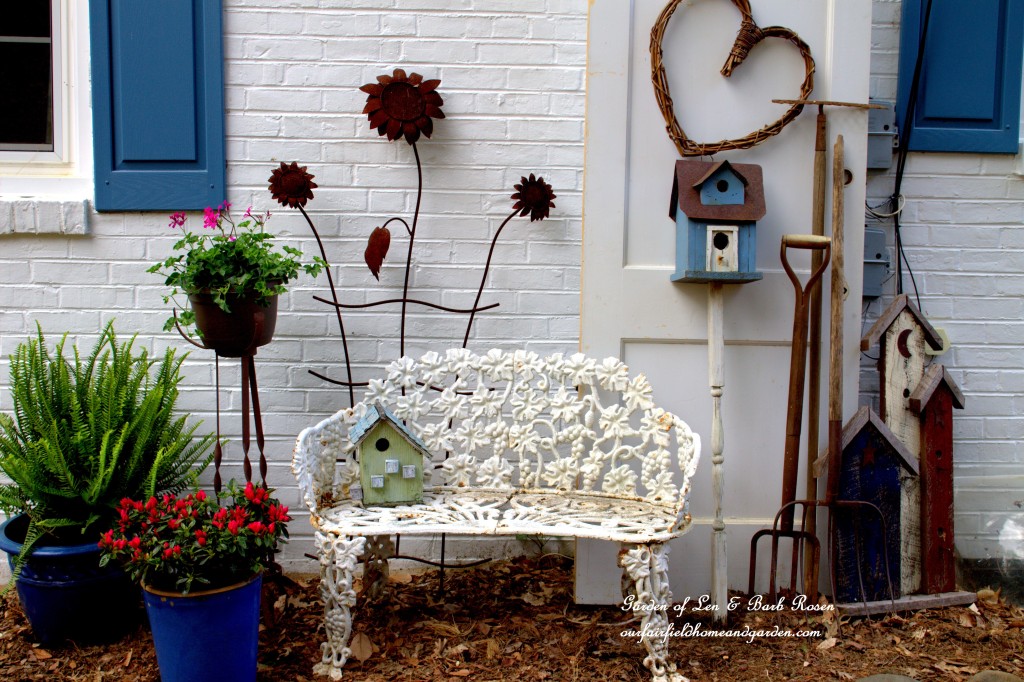 A Country Garden vignette covers the utility boxes! https://ourfairfieldhomeandgarden.com/curb-appeal-hiding-an-eyesore-in-the-garden/